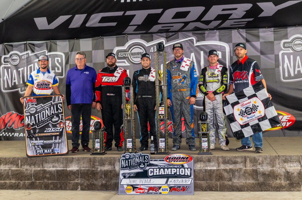 In the NAPA Auto Parts Fan Zone, the Friesen Performance IMCA Modified Big Dance podium featured (left to right) Coty Mallicoat, Greg Nicol of Speedway Motors, Tom Berry Jr., Dakota Sproul, race winner Tim Ward, Dallon Murty, and IMCA President Brett Root on Sept. 6 during the Speedway Motors IMCA Super Nationals fueled by Casey’s at Boone Speedway. (Photo by Byron Fichter Fotography)